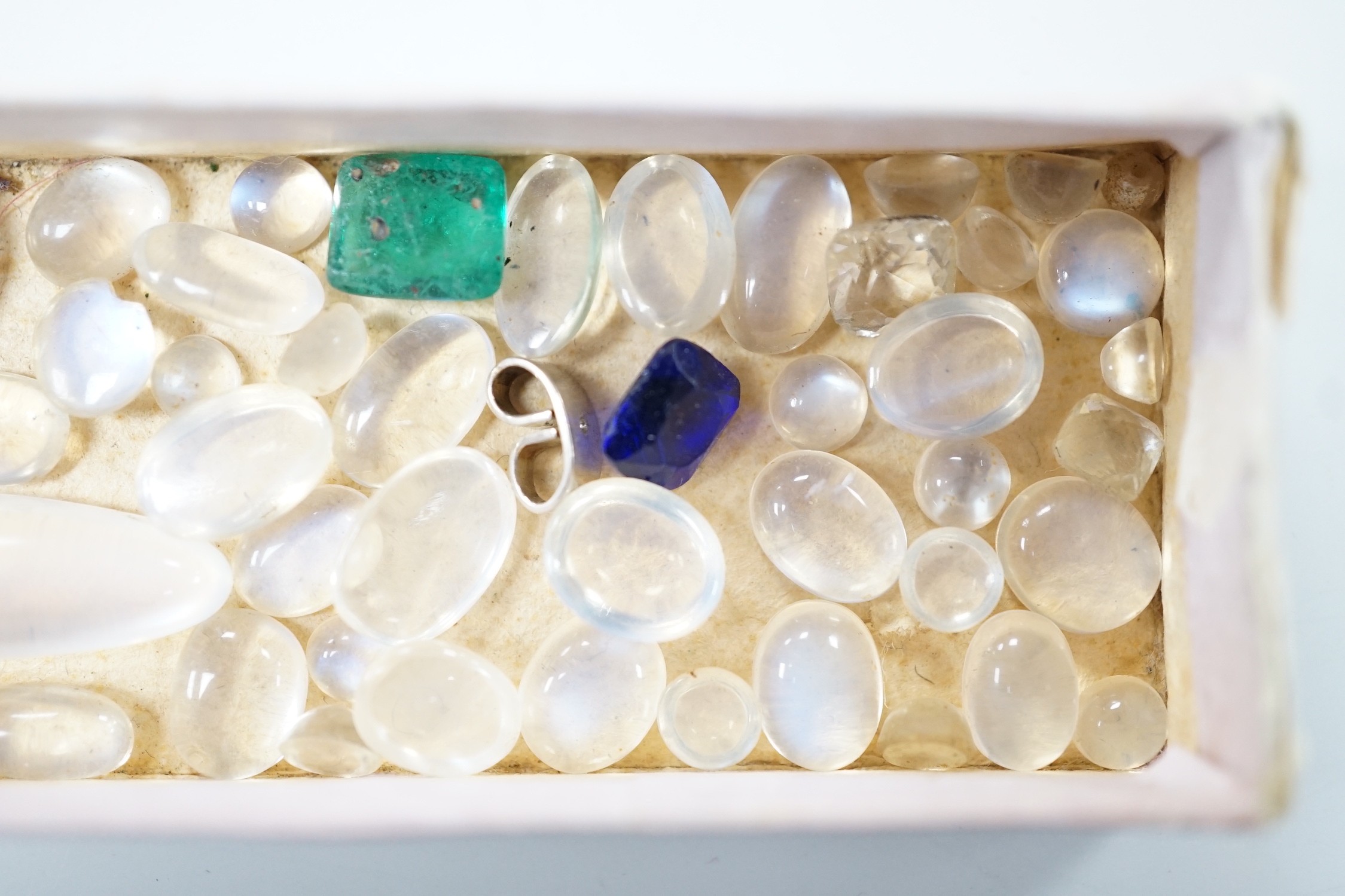 A small quantity of unmounted cabochon moonstones of varying sizes and four other unmounted coloured stones including green paste.